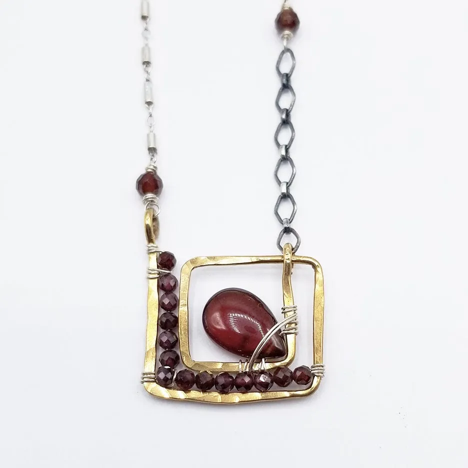 SQUARE SPIRAL WITH CARNELIAN DROP AND FACETED GARNETS NECKLACE