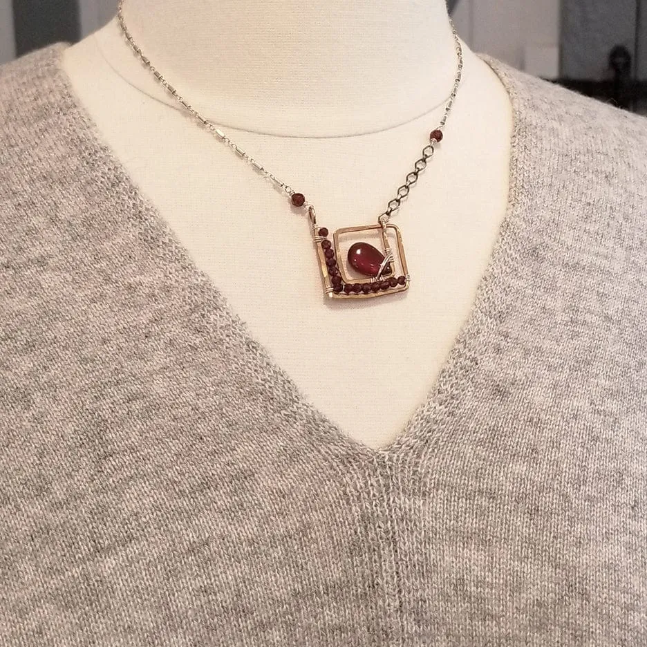 SQUARE SPIRAL WITH CARNELIAN DROP AND FACETED GARNETS NECKLACE